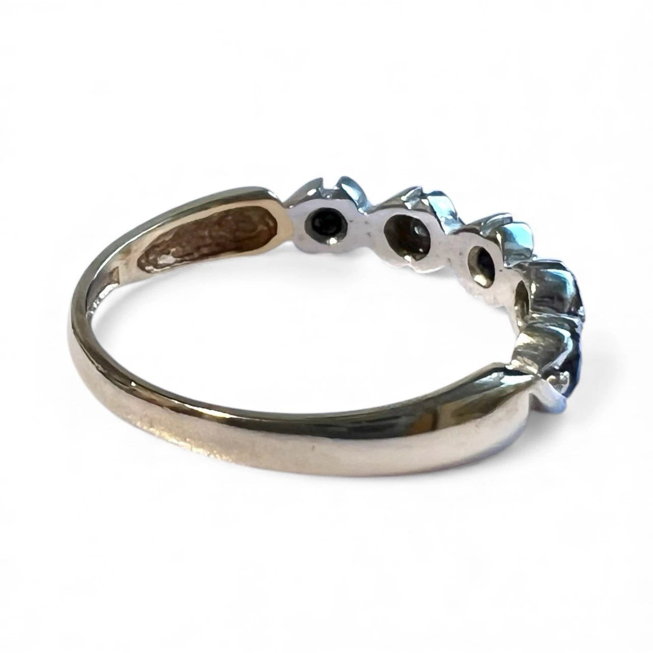 Gild ring with sapphire and diamonds on a white background