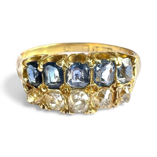 Victorian gold ring with sapphire and diamond gemstones on a white background