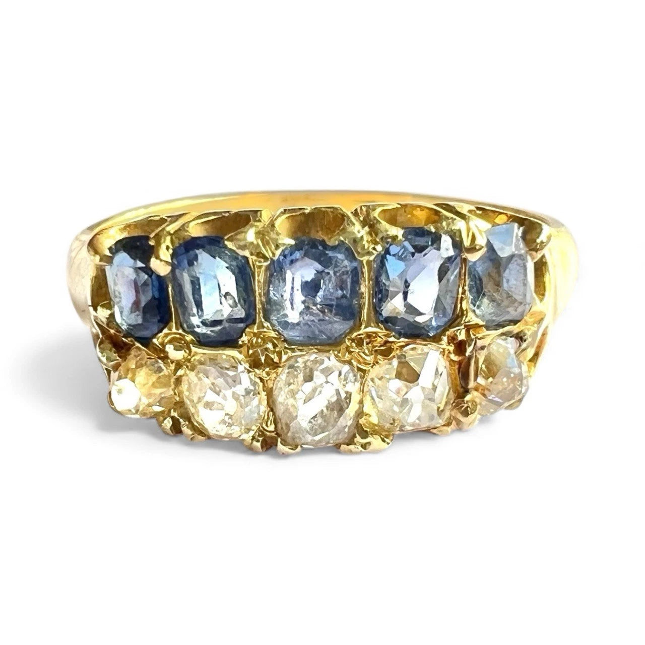 Antique Gold two row ring with sapphire and diamond gemstones on a white background. Close up front view 