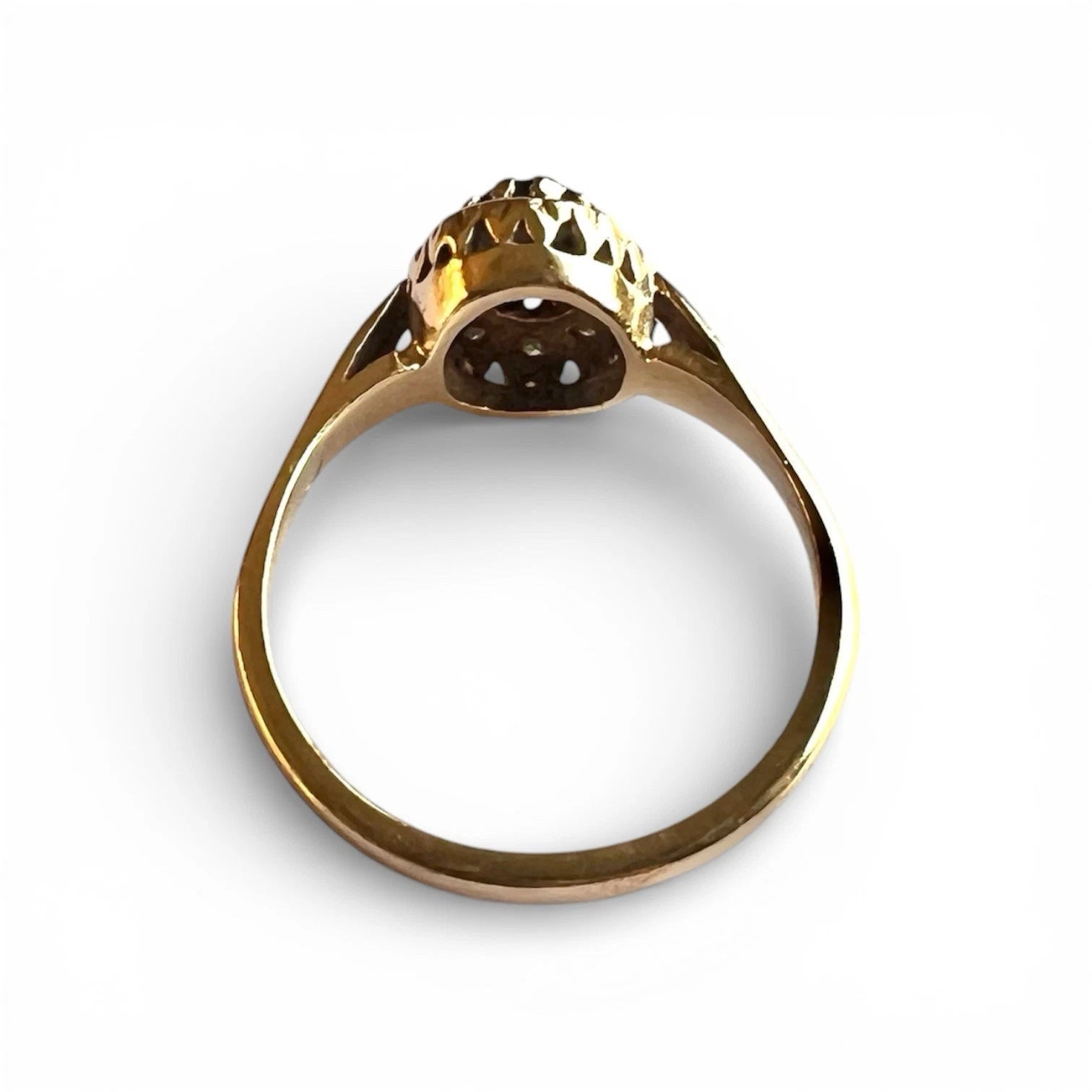 Gold ring with a central gemstone on a white background top down view 