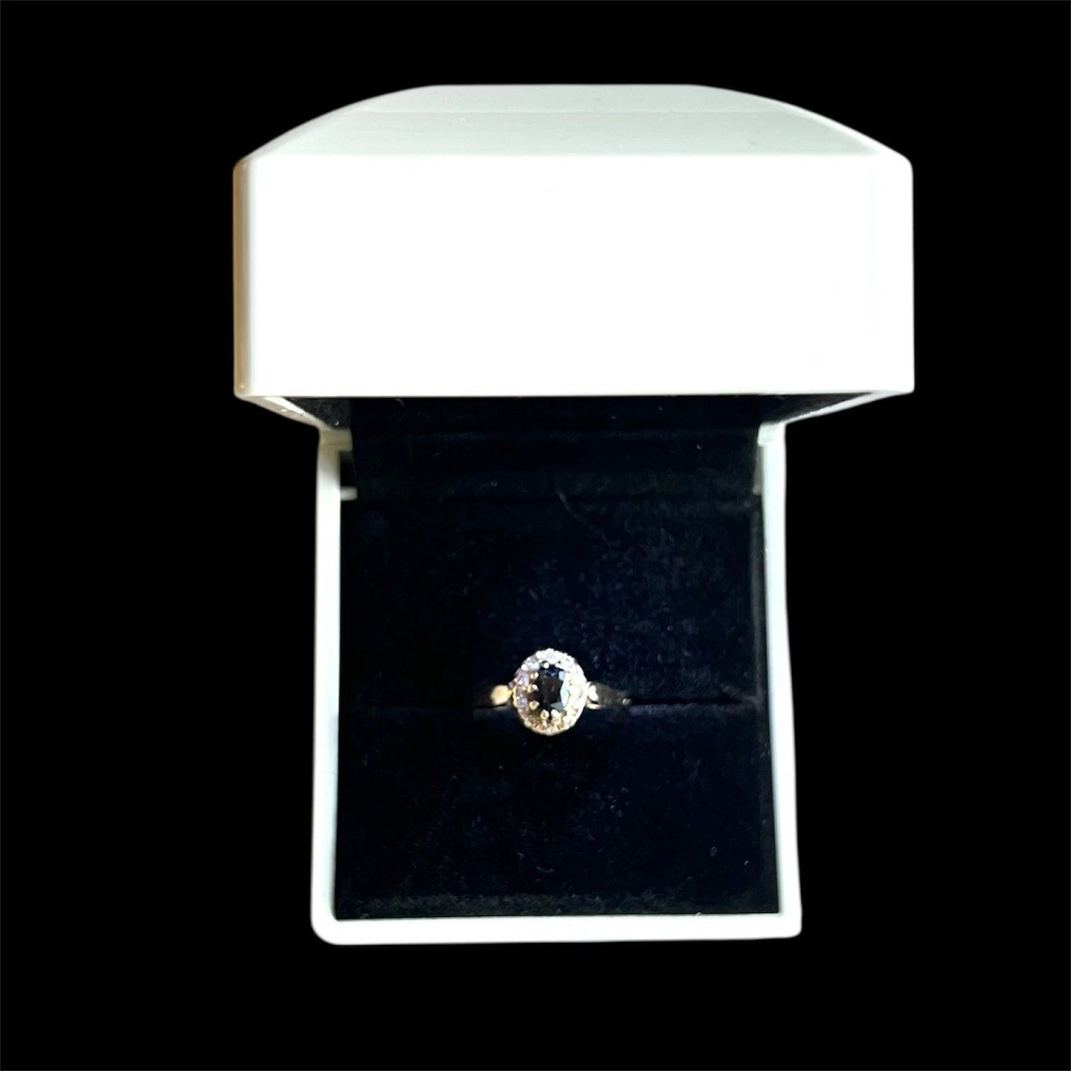 Sapphire and Diamond ring in a white box on a black background