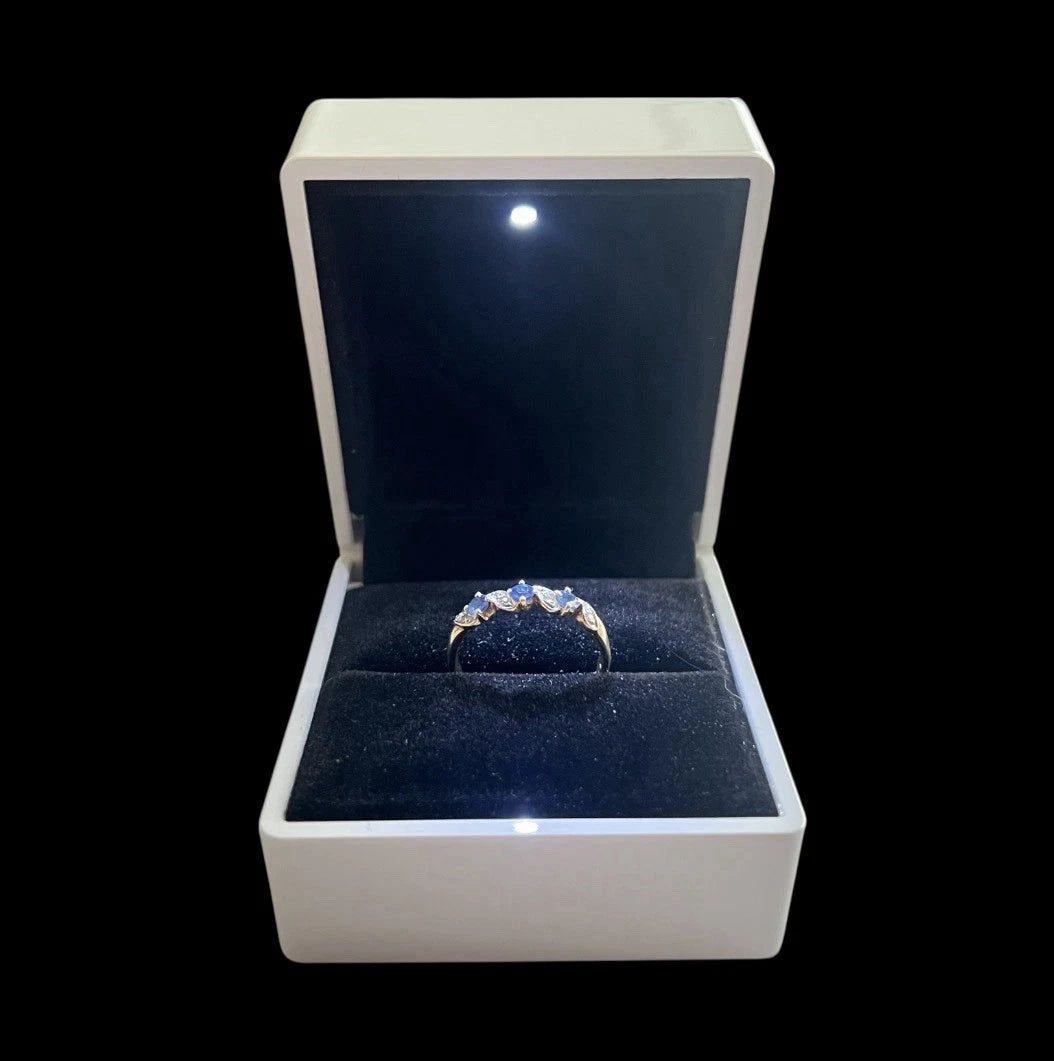 Jewellery box with a ring inside on a black background