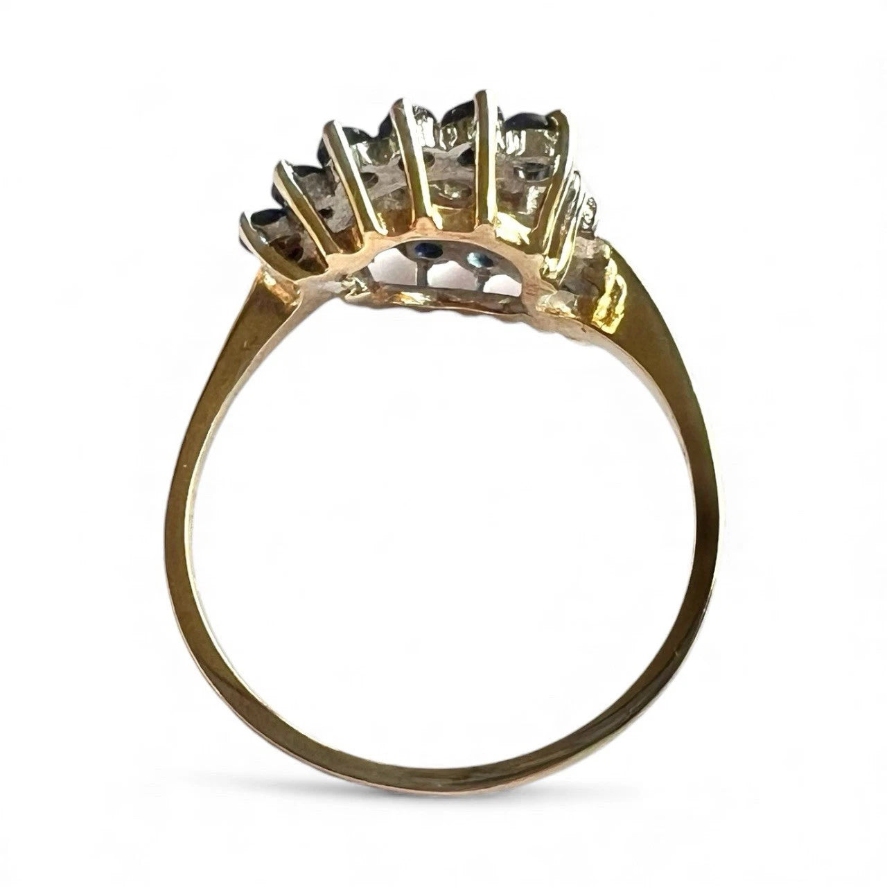 Gold ring with sapphire and diamonds on a white background close up top down view 