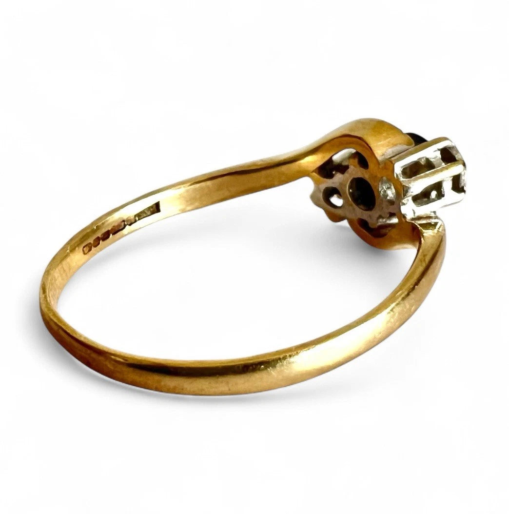 Three Stone gold ring with a sapphire and diamond on a white background