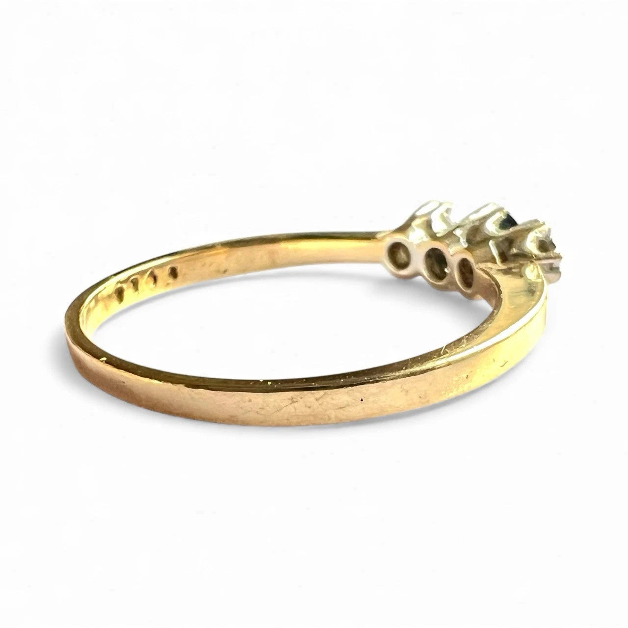 Gold ring with sapphire and diamond on a white background