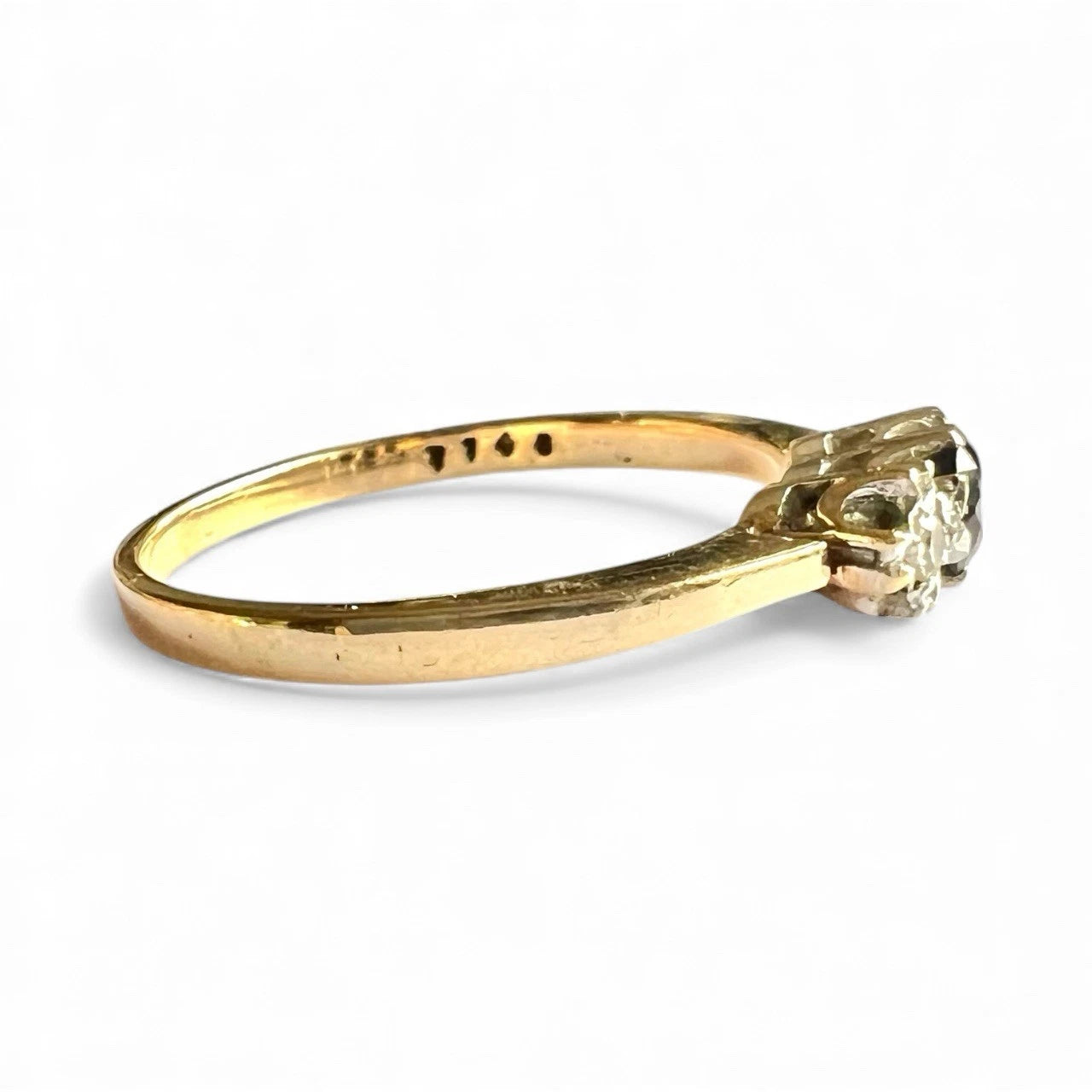 Gold ring with sapphire and diamond on a white background