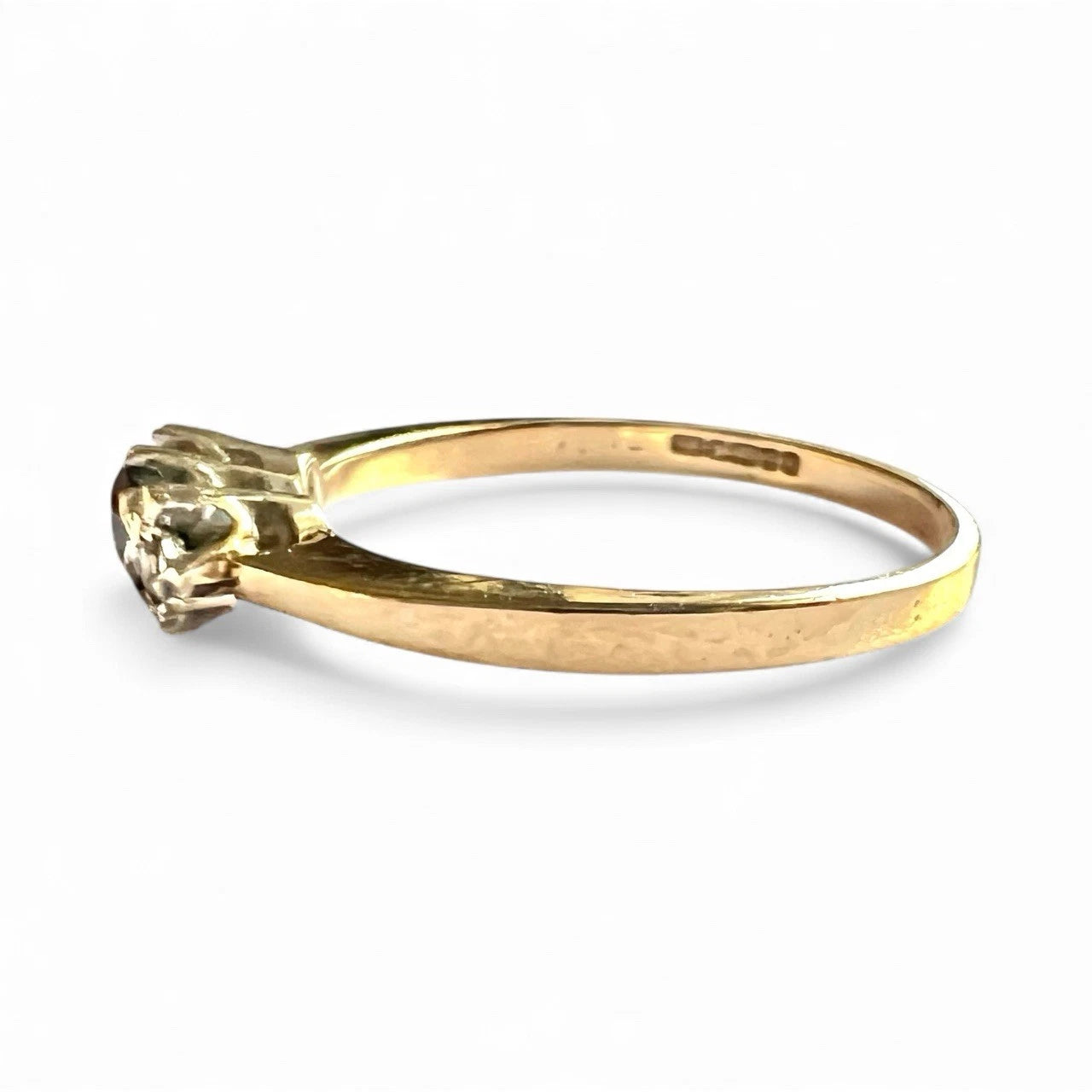 Gold ring with sapphire and diamonds on a white background