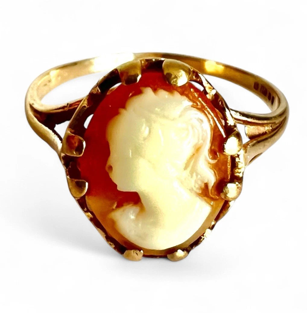 Gold ring with a cameo design on a white background. Close up front view 