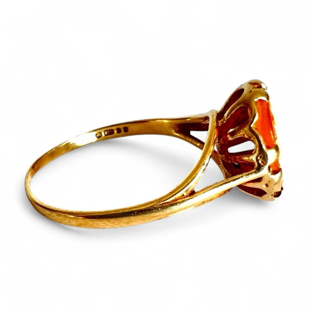 Gold cameo ring with a on a white background. Close up side view 