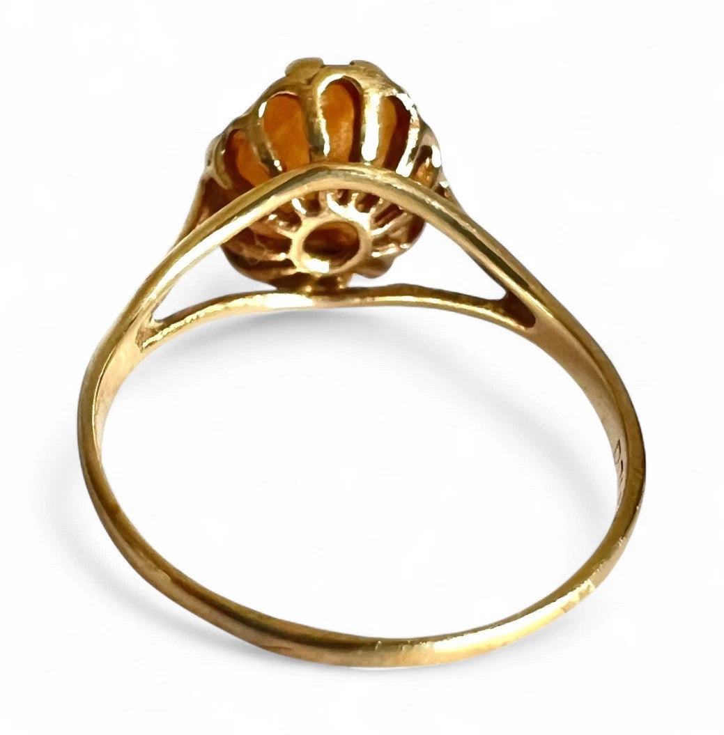 Gold cameo ring on a white background, close up rear view of setting and gold band