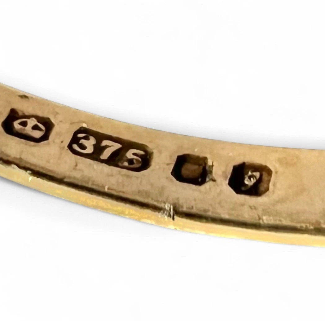 Gold ring with '375' hallmark on a white background