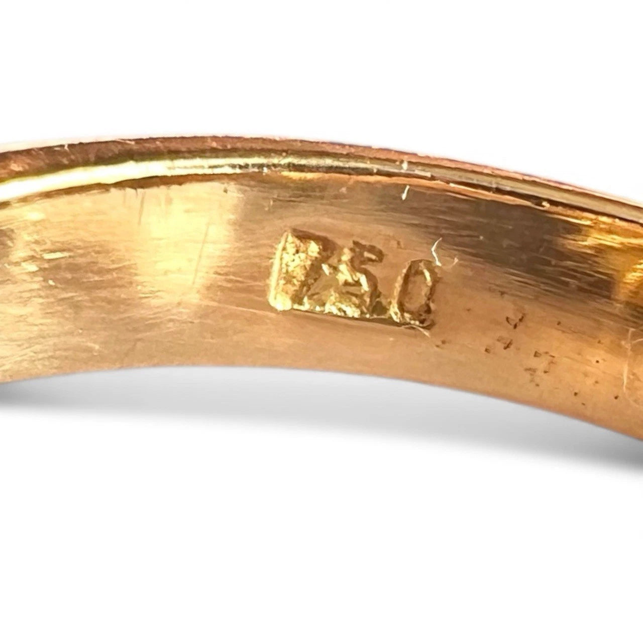 Gold ring with 750 '18K' marking on a white background