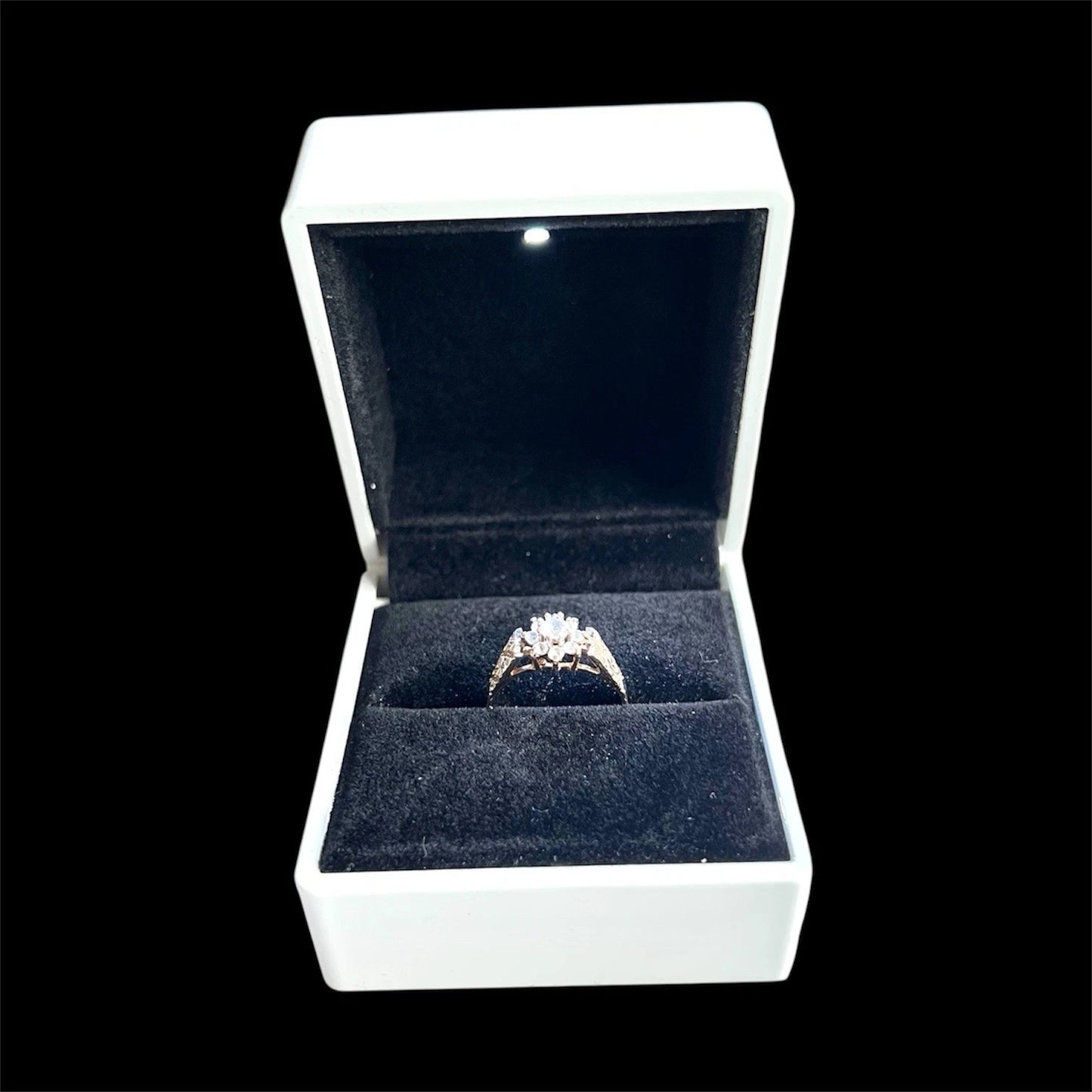 Topaz ring in a white box with a black interior