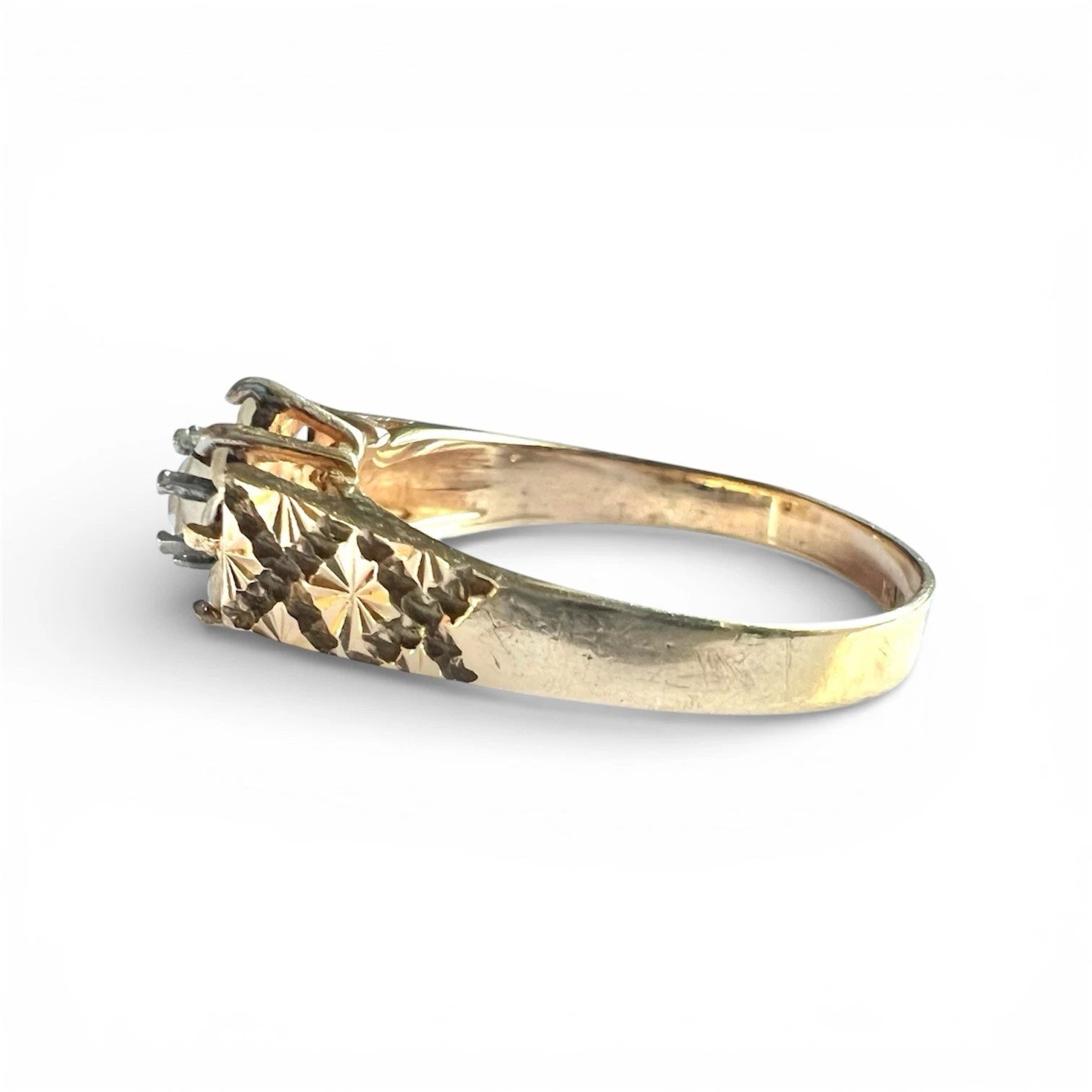 Gold ring with topaz flower cluster  on a white background, side view close up 