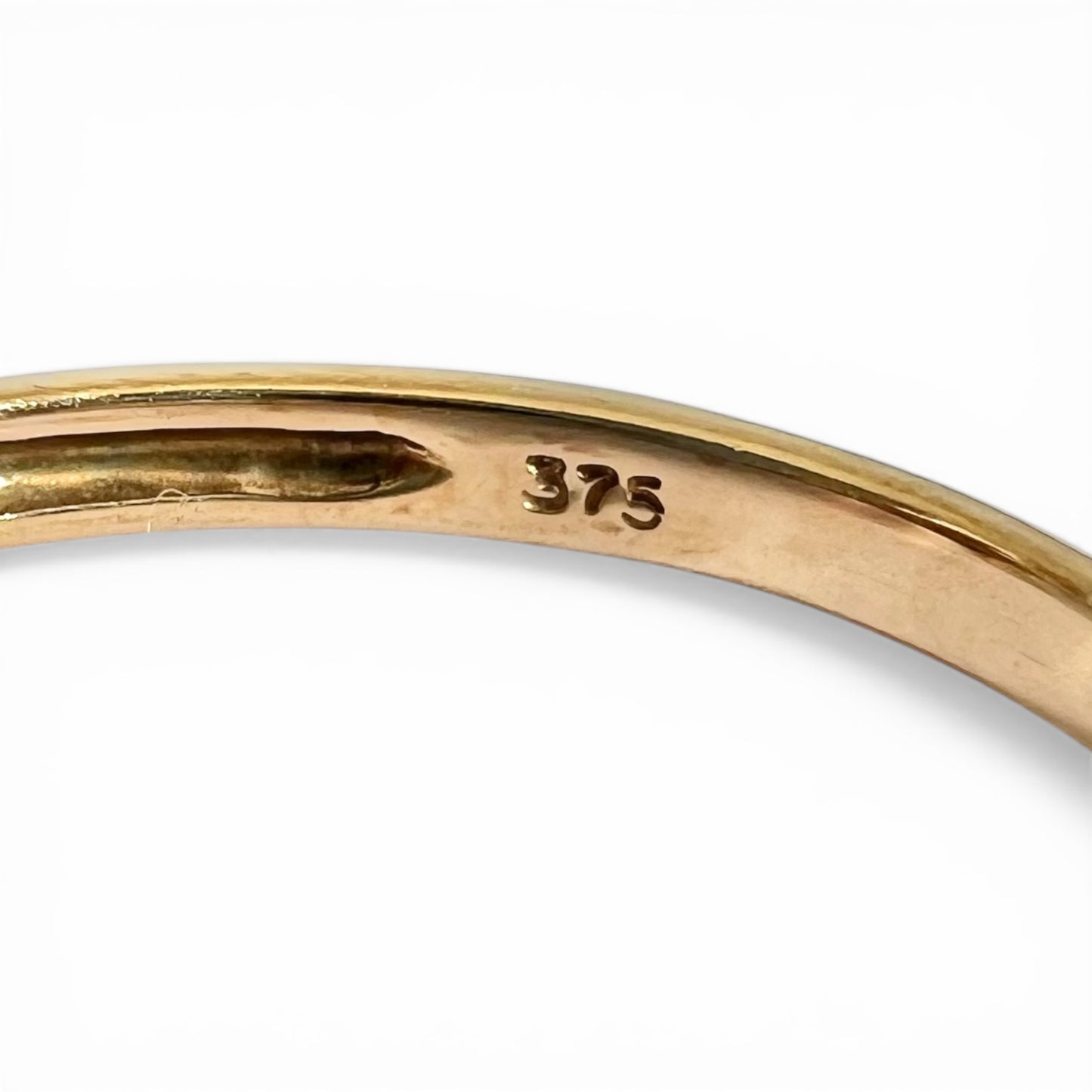 Gold ring with '375' stamp on a white background
