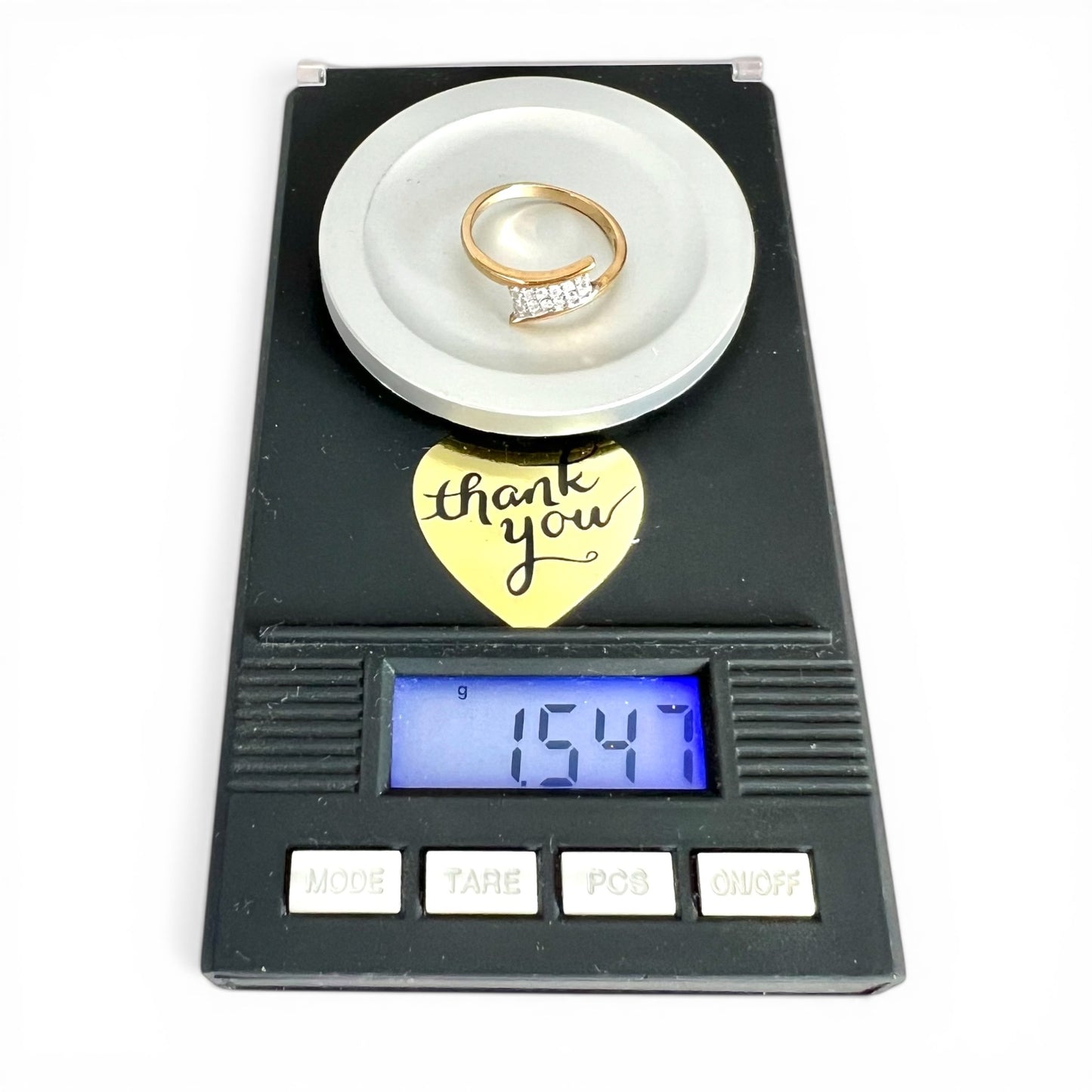 Weighing scales with rings on a white background