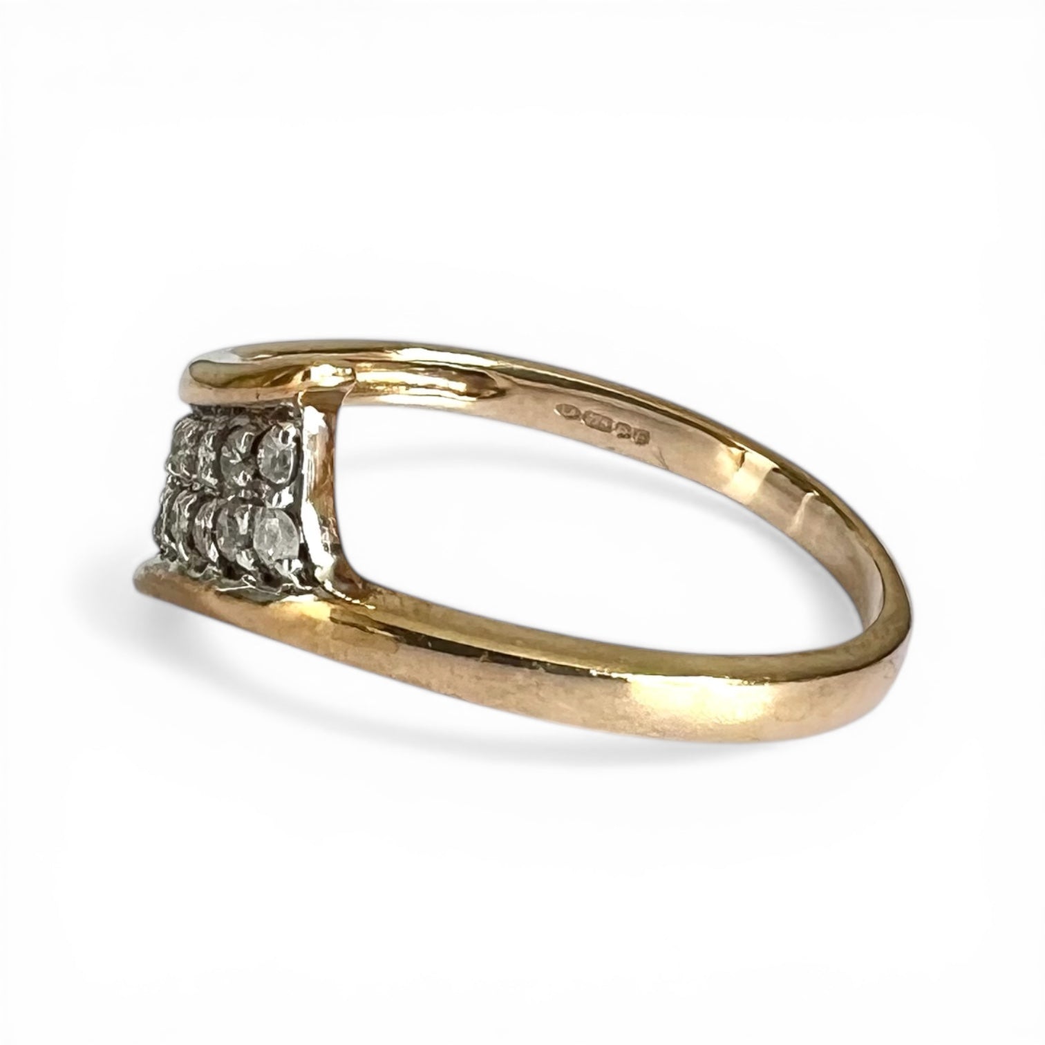 Gold ring with diamond accents on a white background