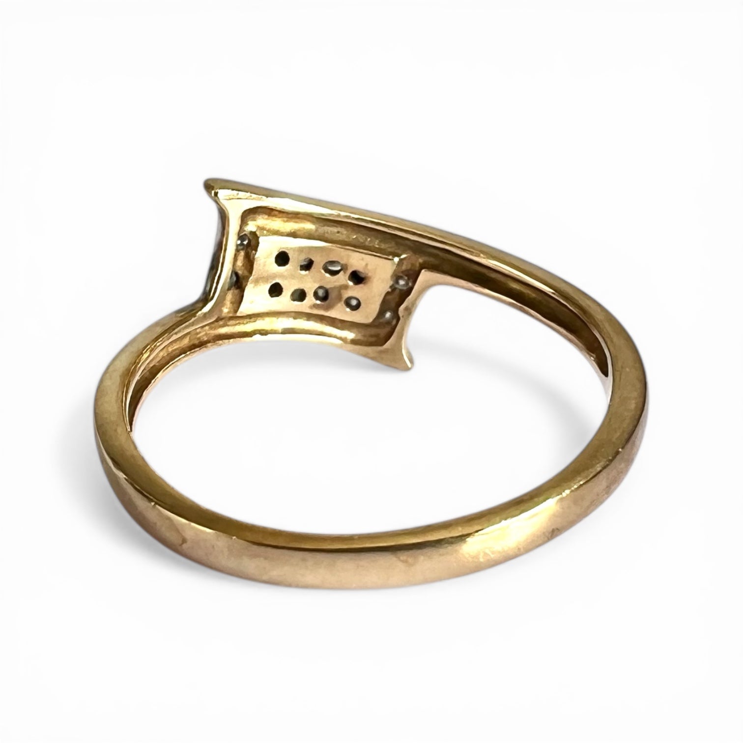 Gold ring rear view of setting and gold band on a white background
