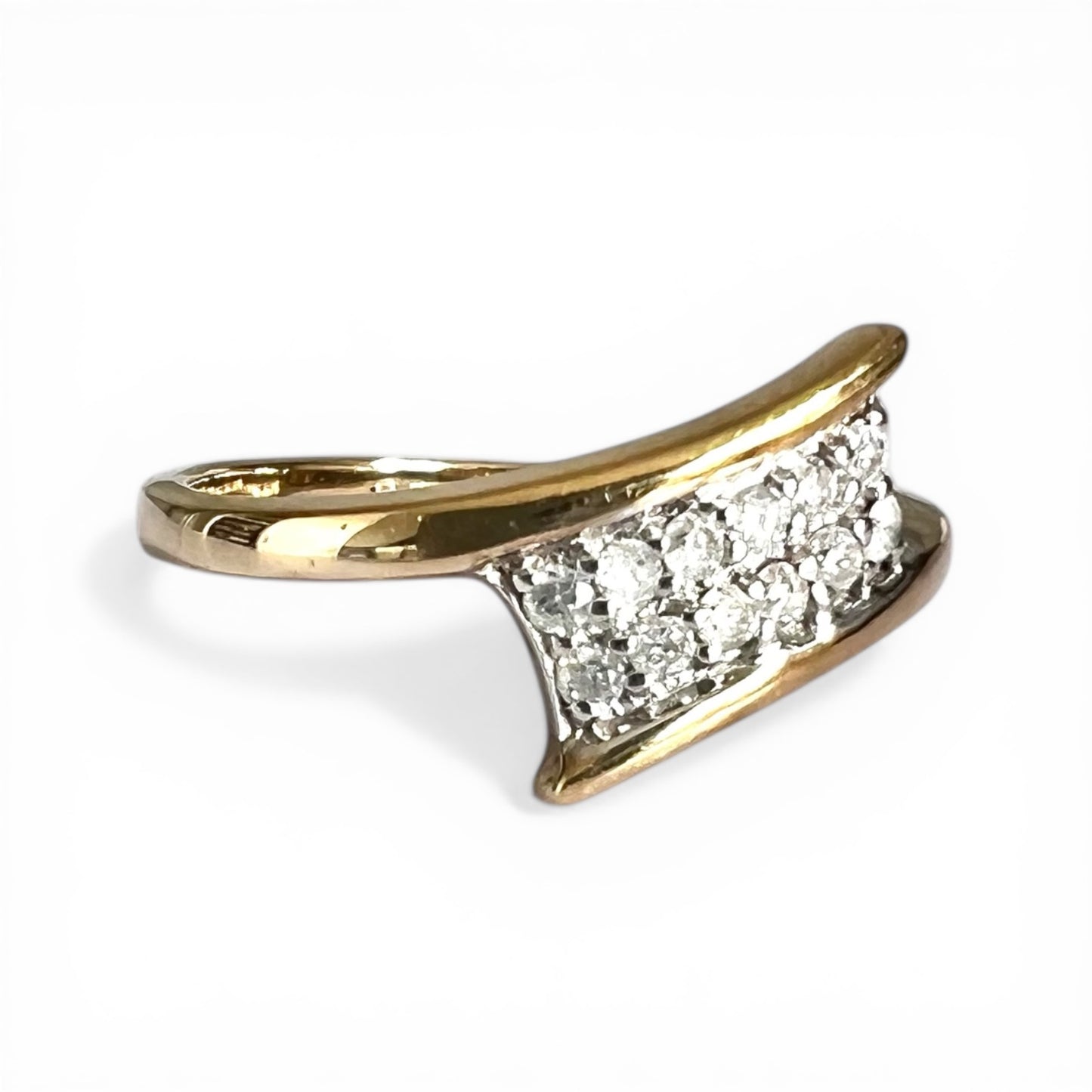 Gold ring with diamond accents on a white background