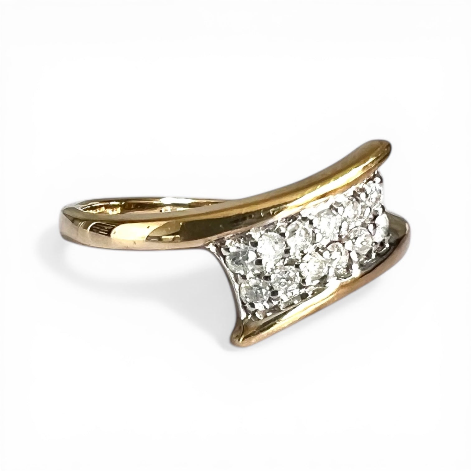 Gold ring with diamond accents on a white background