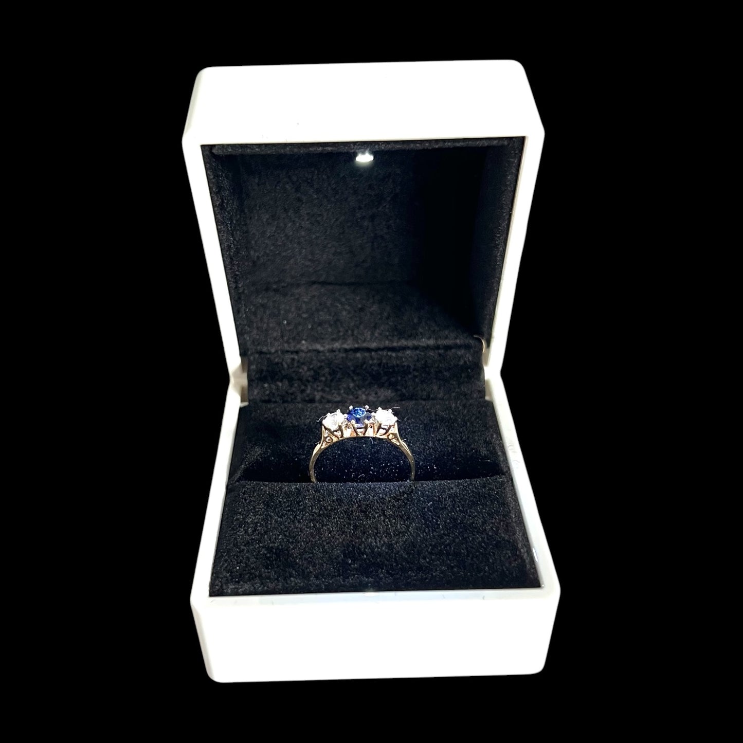 Ring box with a diamond ring inside on a black background Vintage 9ct Gold Sapphire Trilogy Ring – Three Stone Design, Size P 1/2