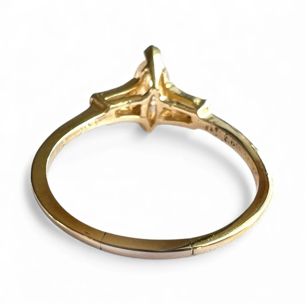 Gold ring with a diamond on a white background