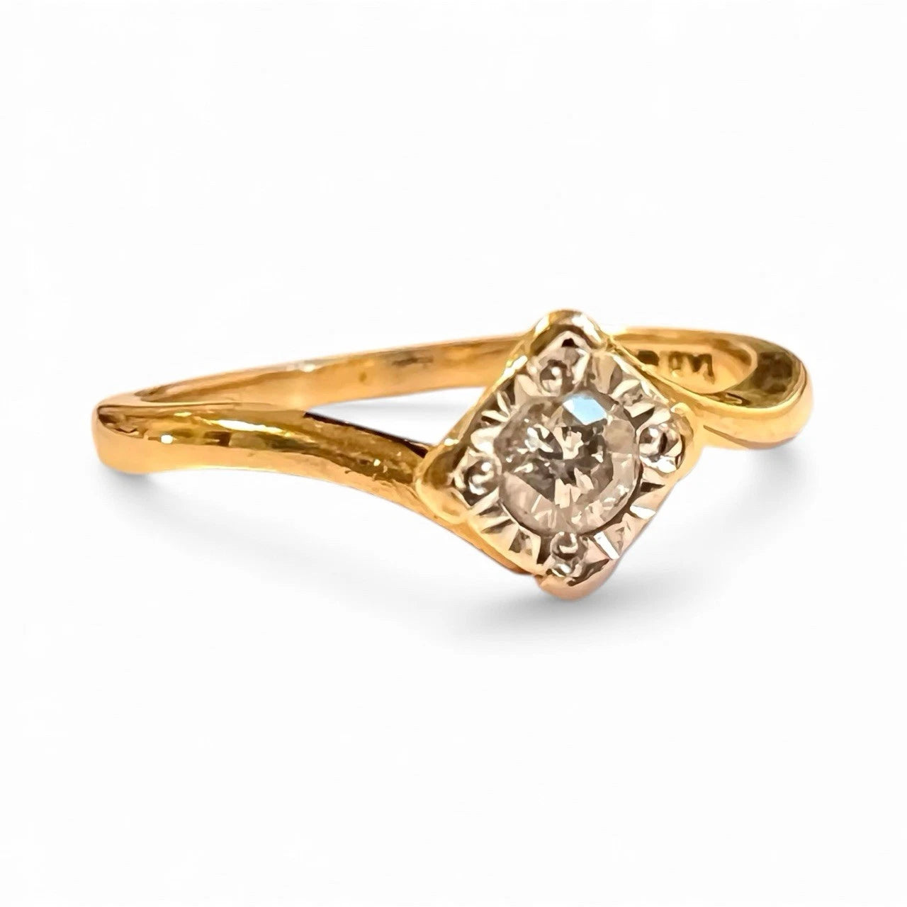 Gold ring with a diamond on a white background