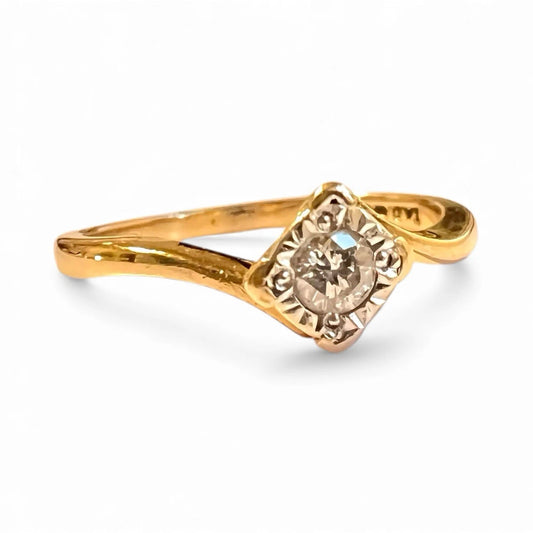 Gold ring with a diamond on a white background